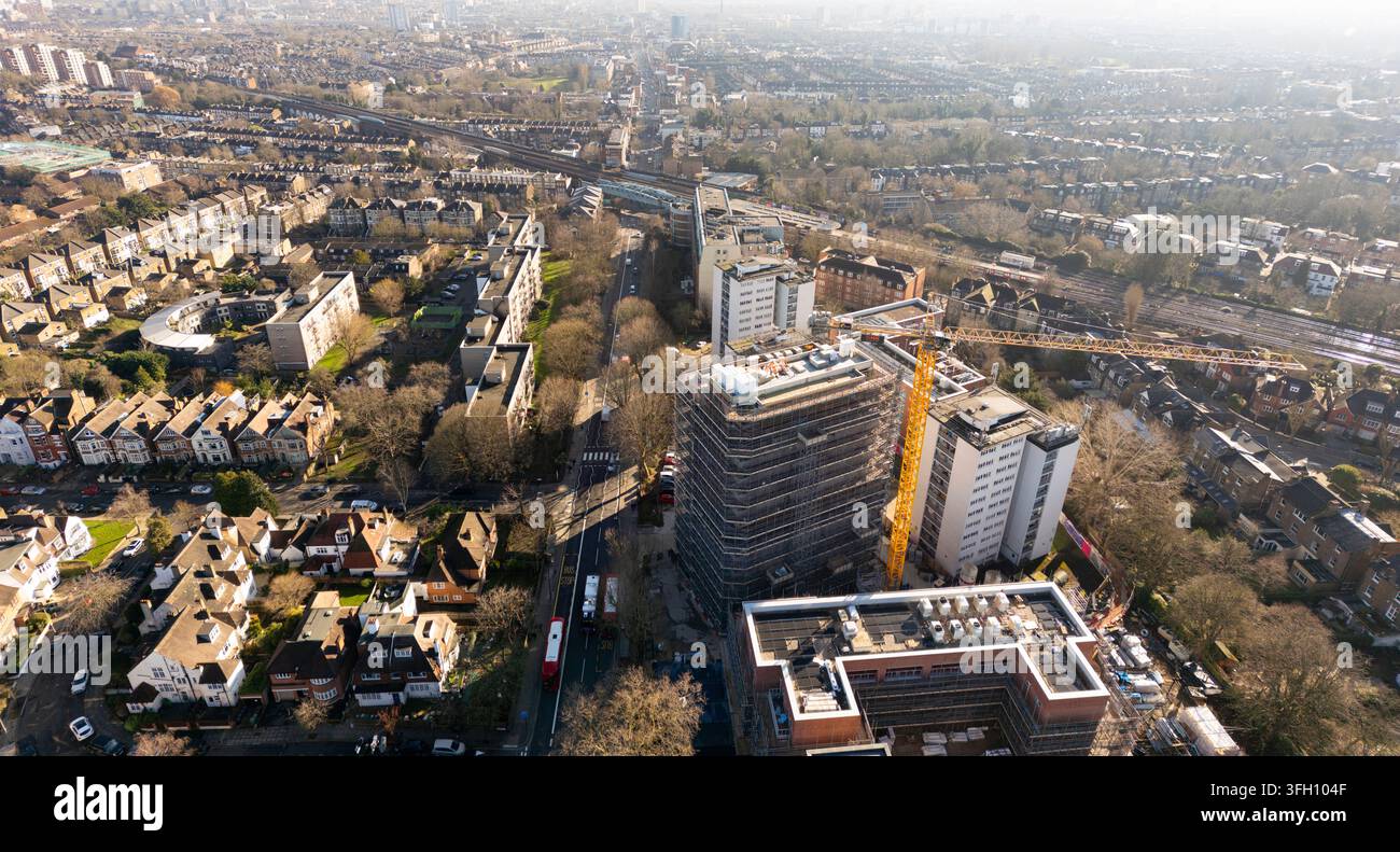 Les équipes de construction utilisent une grue pour rénover Windmill Court sur Shoot Up Hill, Kilburn, Londres, améliorant les logements résidentiels urbains. Banque D'Images