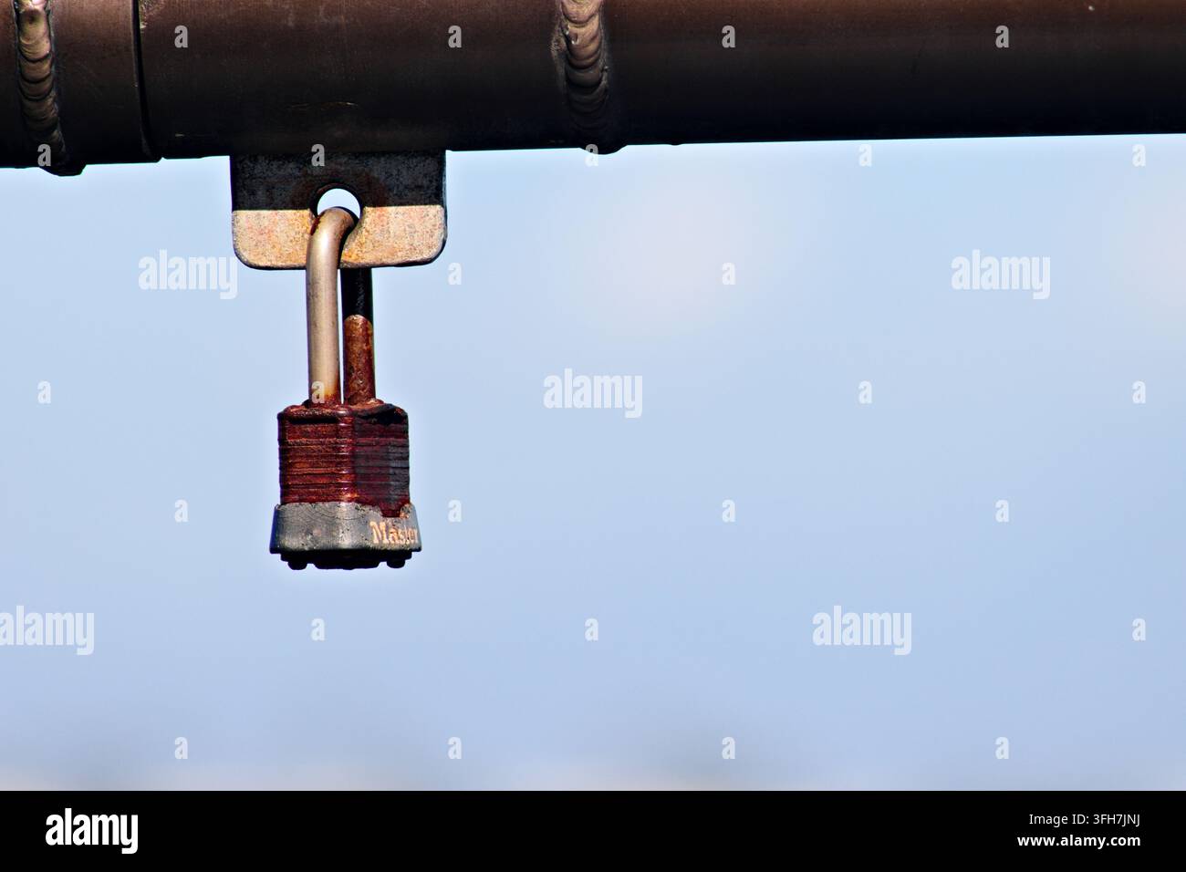 Cadenas rouillé accroché à une structure de pier métallique à Huntington Beach, Californie Banque D'Images