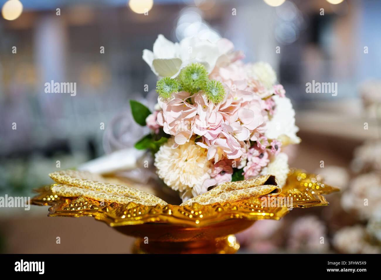 Bouquet de fleurs de mariage pastel élégant sur un plateau doré traditionnel Banque D'Images