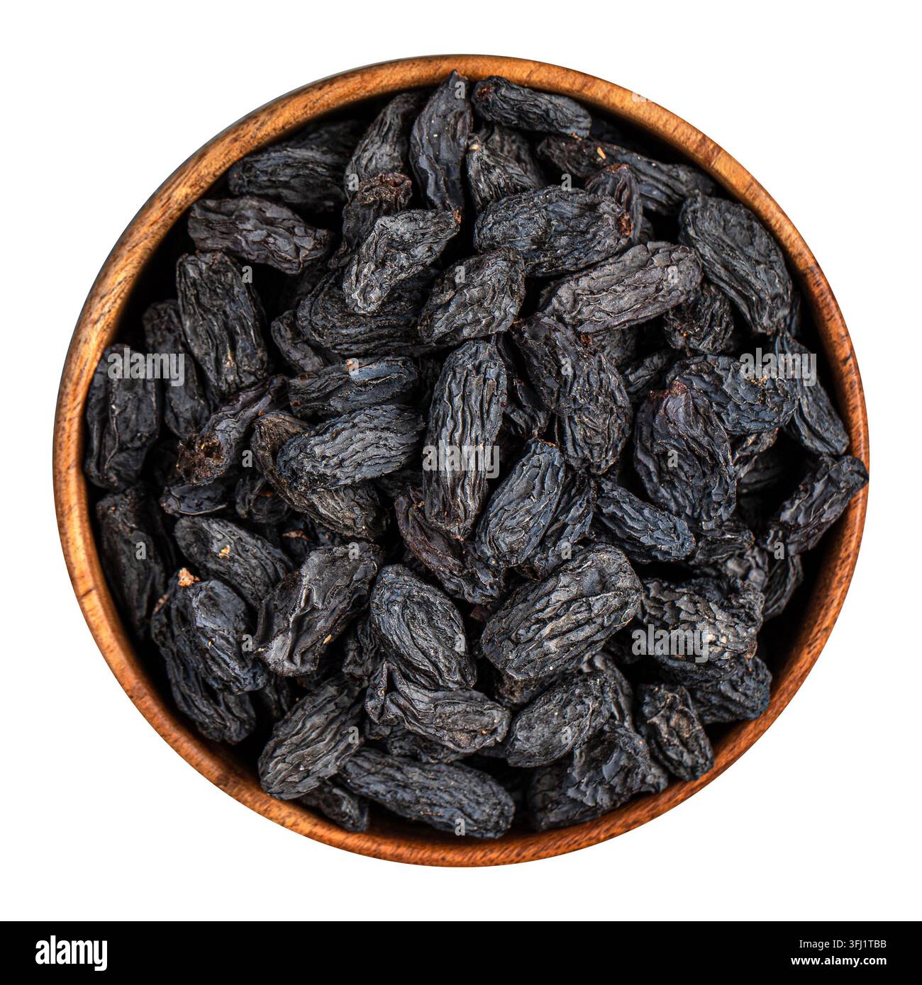 Raisins noirs dans un bol en bois Banque D'Images