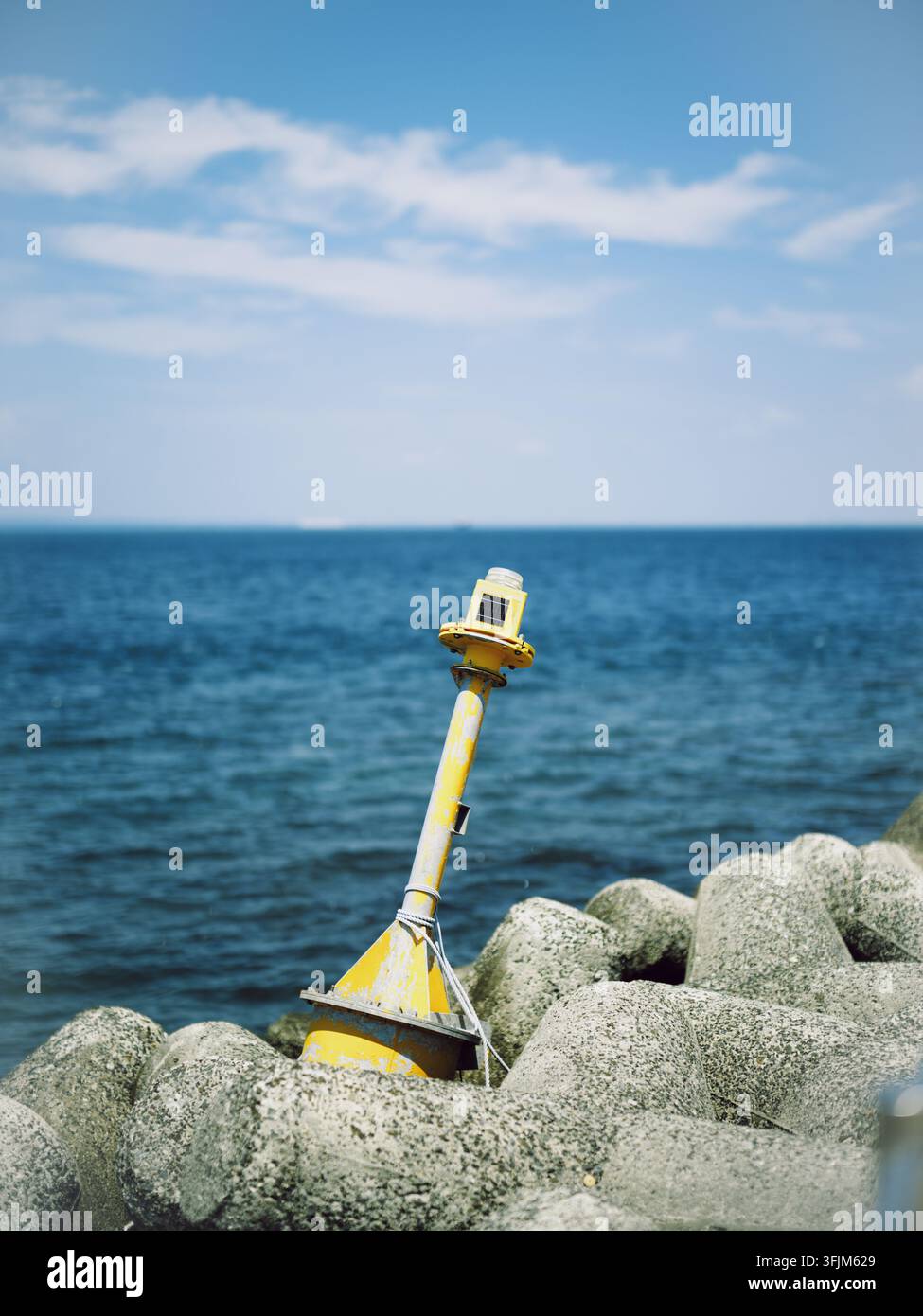 Bouée nautique jaune coincée entre des tetrapodes en béton sur la côte de l'île de Himakajima Banque D'Images