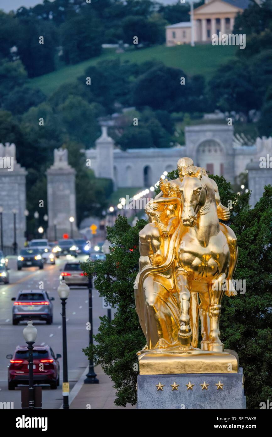 Statue du Sacrifice doré près d'Arlington House à Washington DC | WASHINGTON — La sculpture dorée du Sacrifice s'élève au-dessus du pont mémorial d'Arlington, avec Arlington House et les portes du cimetière visibles au loin, mercredi 17 septembre 2025. Le groupe équestre se dresse à l'entrée est du pont sur le Lincoln Memorial Circle dans West Potomac Park, faisant partie de l'ensemble du pont mémorial d'Arlington du Service des parcs nationaux. Leo Friedlander a modélisé le cavalier en Mars, regardant une figure féminine terrienne représentant la nation qu'il commande. L'Italie a offert la statue comme cadeau d'après-guerre, la dorant au feu à Fl Banque D'Images