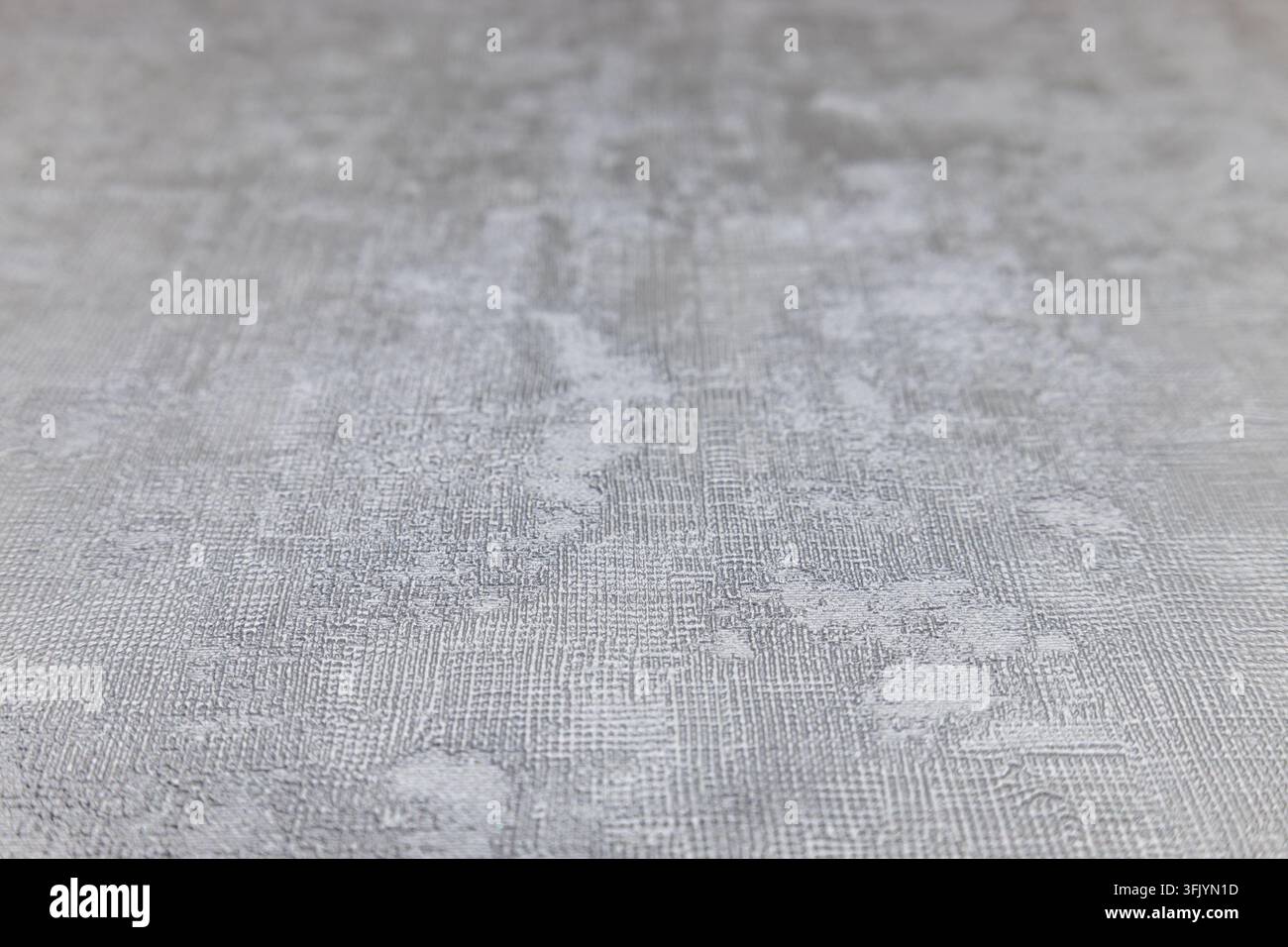 Gros plan d'une surface grise texturée avec un motif de plâtre subtil et de la profondeur Banque D'Images