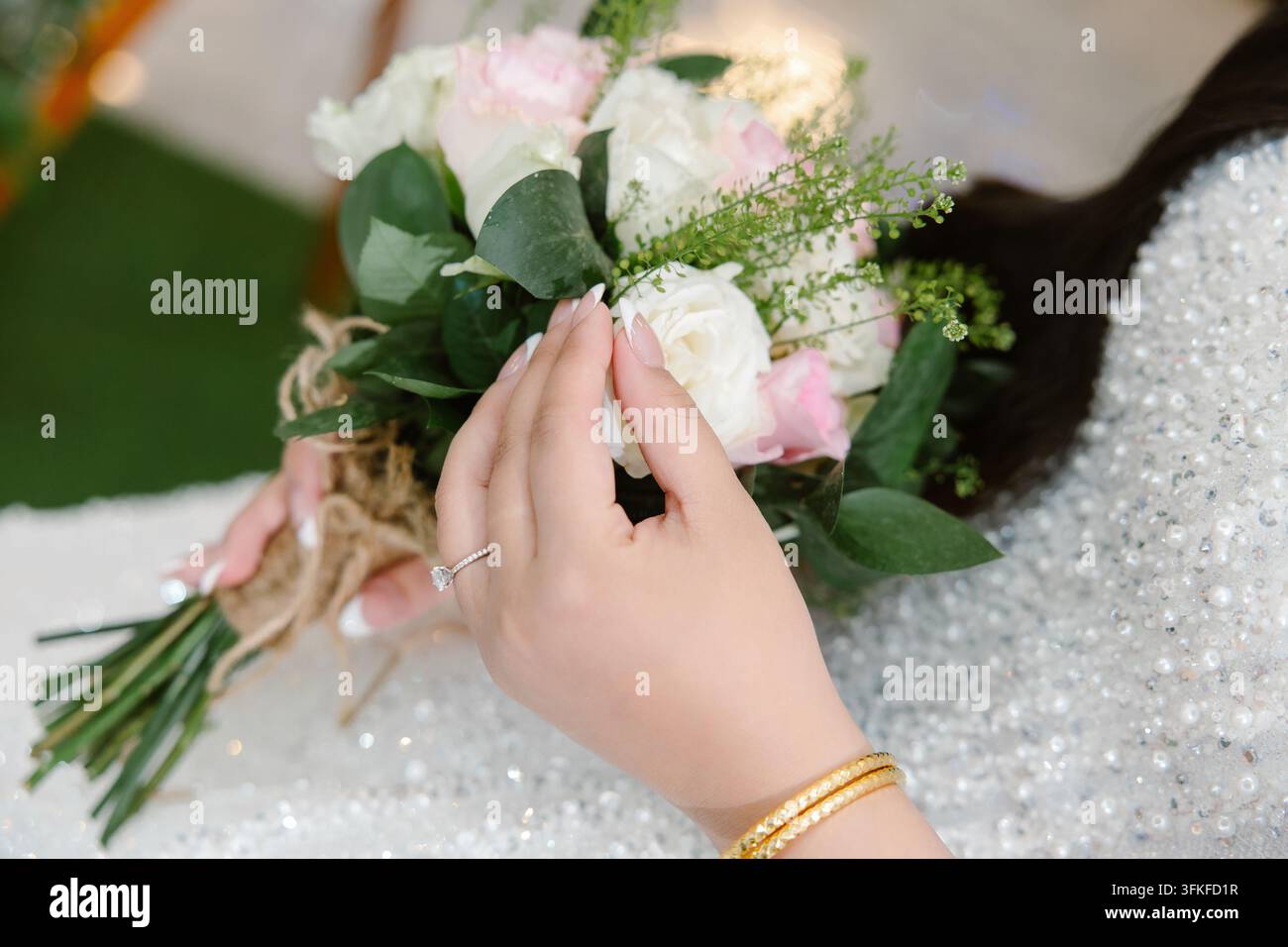 Close-up d'une mariée tenant un bouquet de mariage avec une bague en diamant Banque D'Images