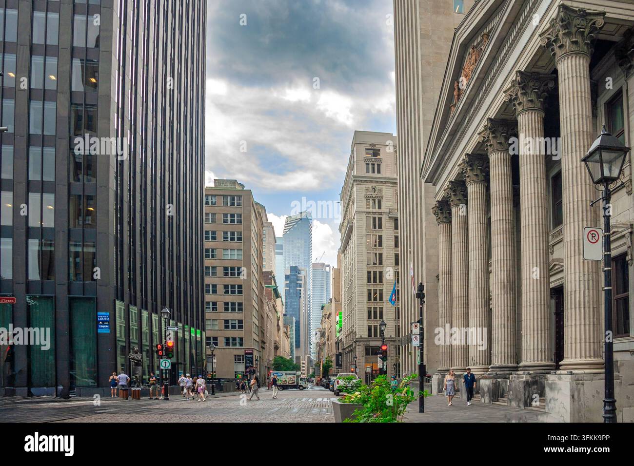Rue Saint-Jacques avec la façade colonnada de la BMO Bank of Montreal sur la Place d'Armes et les gratte-ciel du centre-ville au loin. Montréal, Québec, Canada, Amérique du Nord Banque D'Images