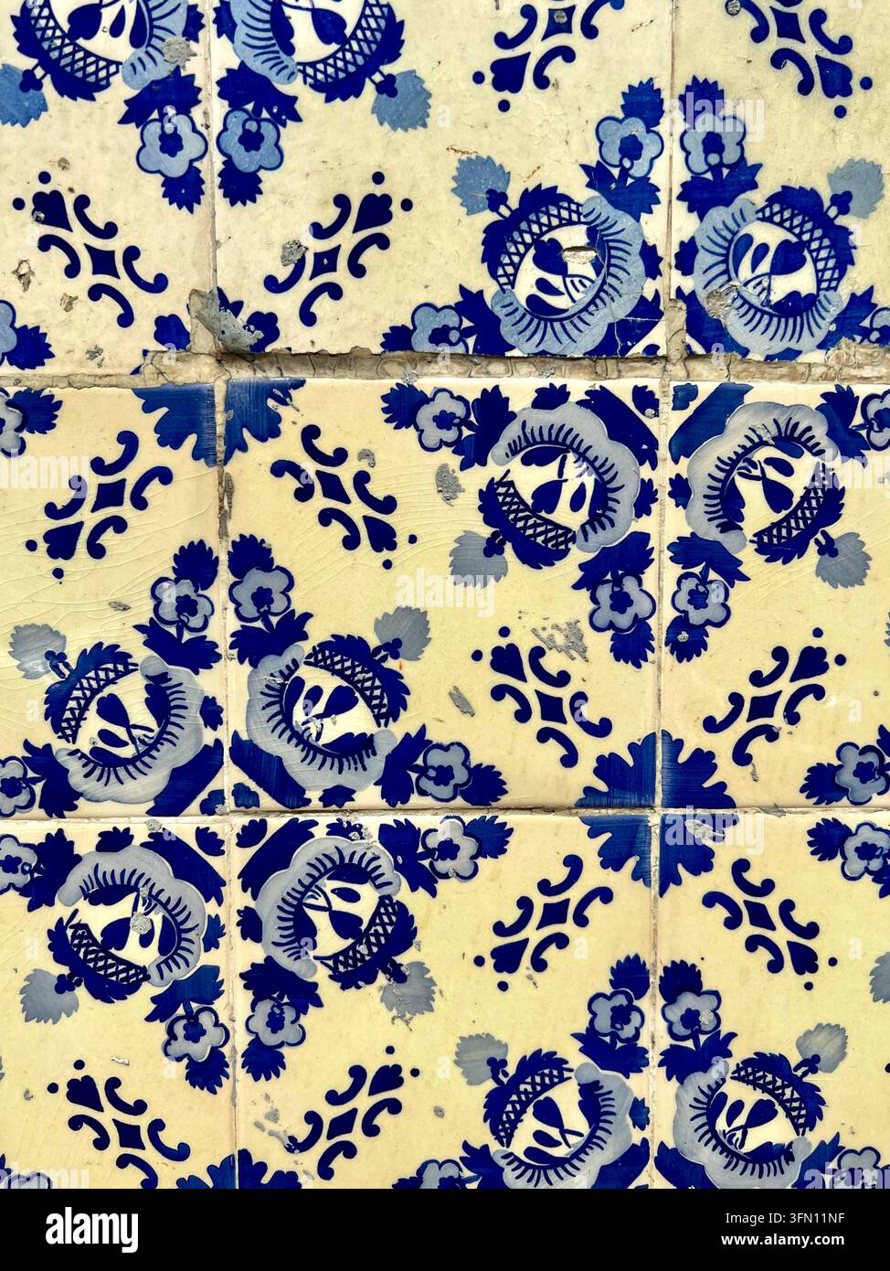 Anciens carreaux de céramique azulejo bleu et blanc à motif floral sur un mur érodé au Portugal - Image de stock capturée avec un smartphone