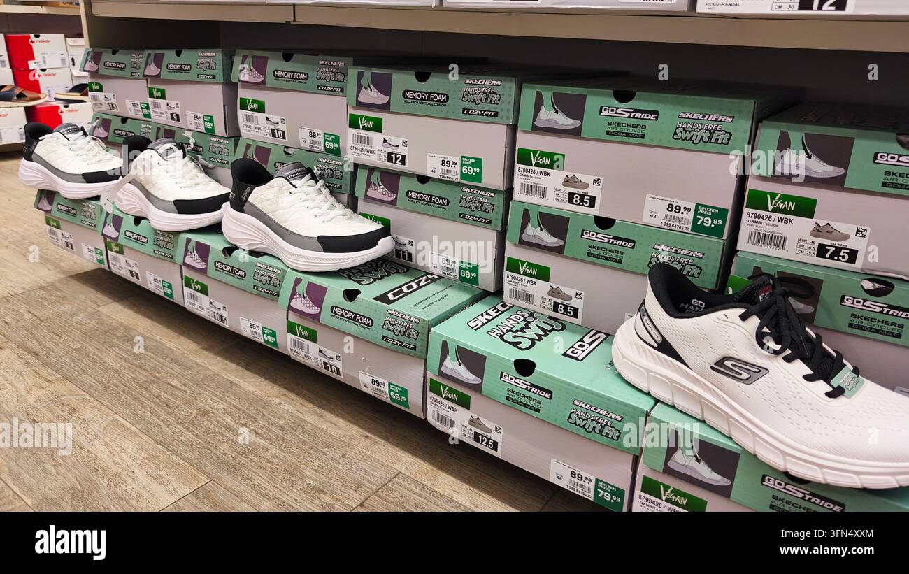 Hagen, Allemagne - 24 juin 2026 : Des baskets et des boîtes à chaussures Skechers exposés sur les étagères de Deichmann. Banque D'Images