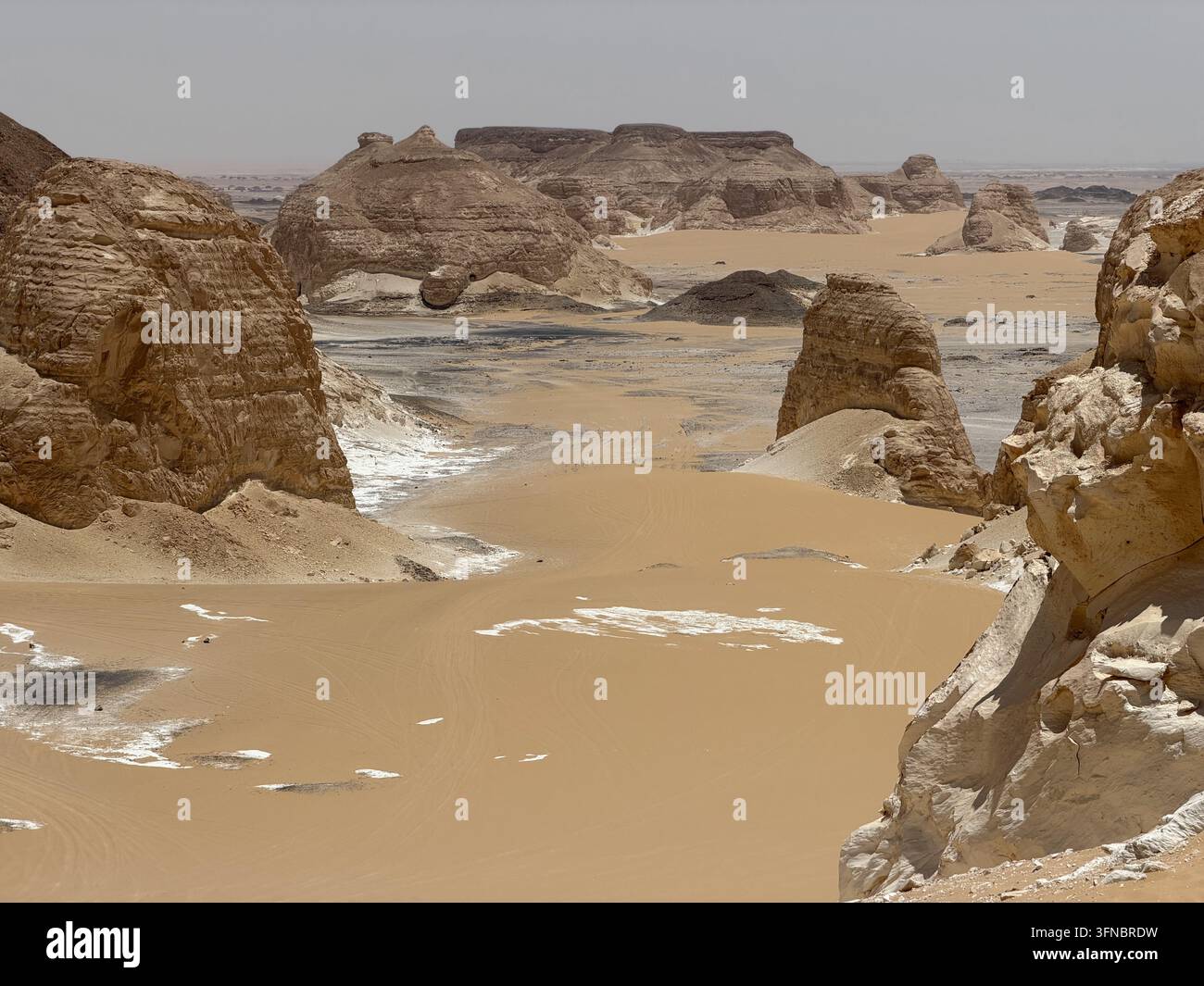 Piliers de calcaire blanc dispersés sur du sable doré, photographiés dans le parc national du Désert Blanc dans le désert de l'Ouest égyptien. - Image de stock capturée avec un smartphone
