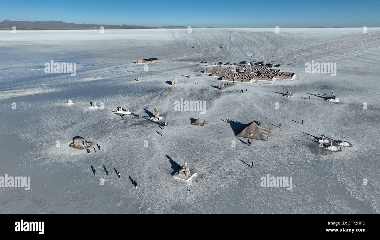Vue aérienne des plaines salées d'Uyuni mettant en scène le terrain rocheux de l'île d'Incahuasi avec des structures en pierre et des cactus sous un ciel dégagé à Nor Lipez, De Banque D'Images