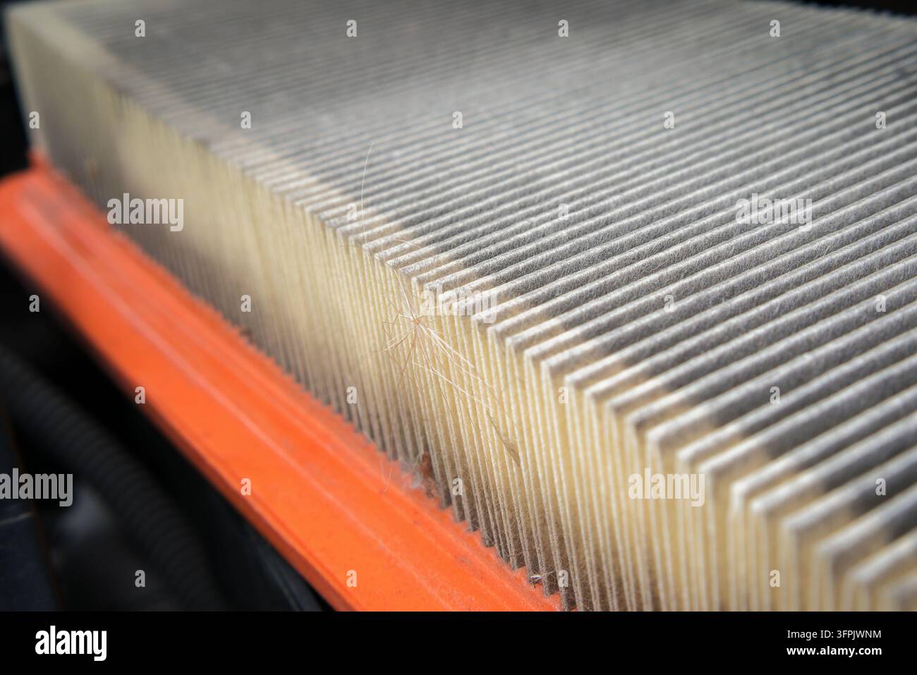 Vue macro détaillée d'un élément de filtre à air moteur de véhicule bouché prêt à être remplacé. Photographie de stock de pièces détachées automobiles industrielles avec élégance Banque D'Images