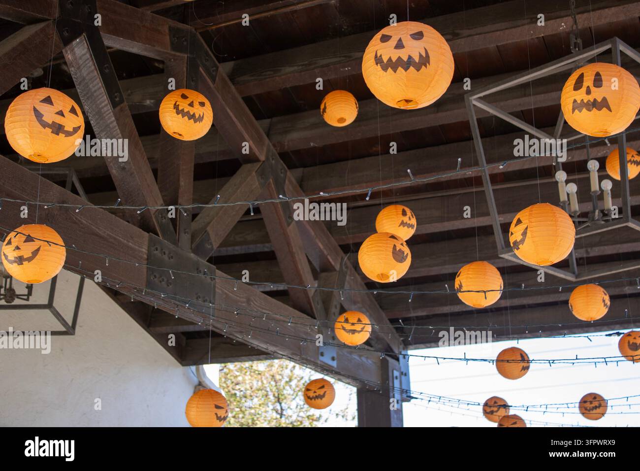 Lanternes Jack-O'-Lantern d'Halloween suspendues sous une passerelle couverte Banque D'Images