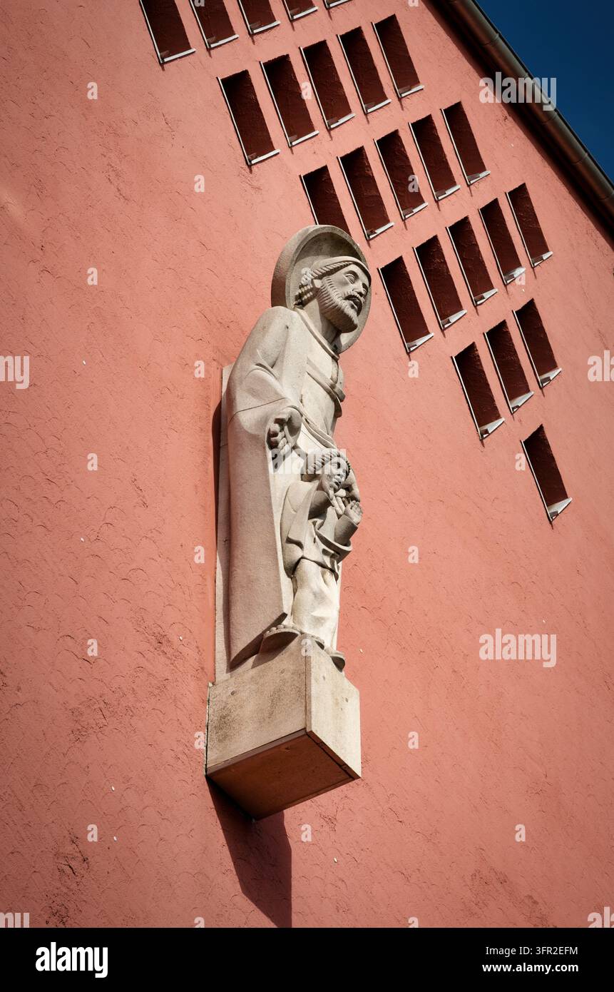 Détail de la statue en pierre de Saint Joseph avec l'enfant Jésus sur la façade rose de l'église Saint-Joseph à Francfort-Bornheim Banque D'Images