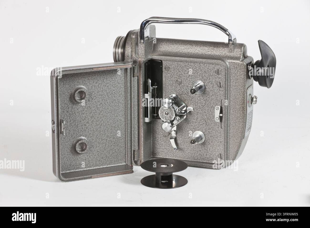 L'image montre une caméra de film vintage classique avec un magazine ouvert et des mécanismes visibles sur un fond neutre. Le cliché met en valeur la technique Banque D'Images