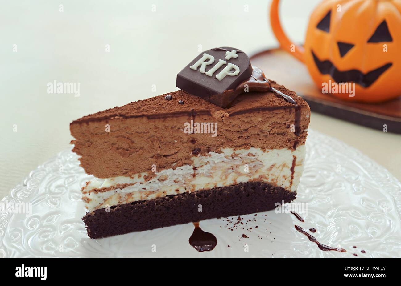 Délicieux gâteau au chocolat triple couche d'Halloween garni d'une pierre tombale en chocolat effrayante avec inscription RIP Banque D'Images