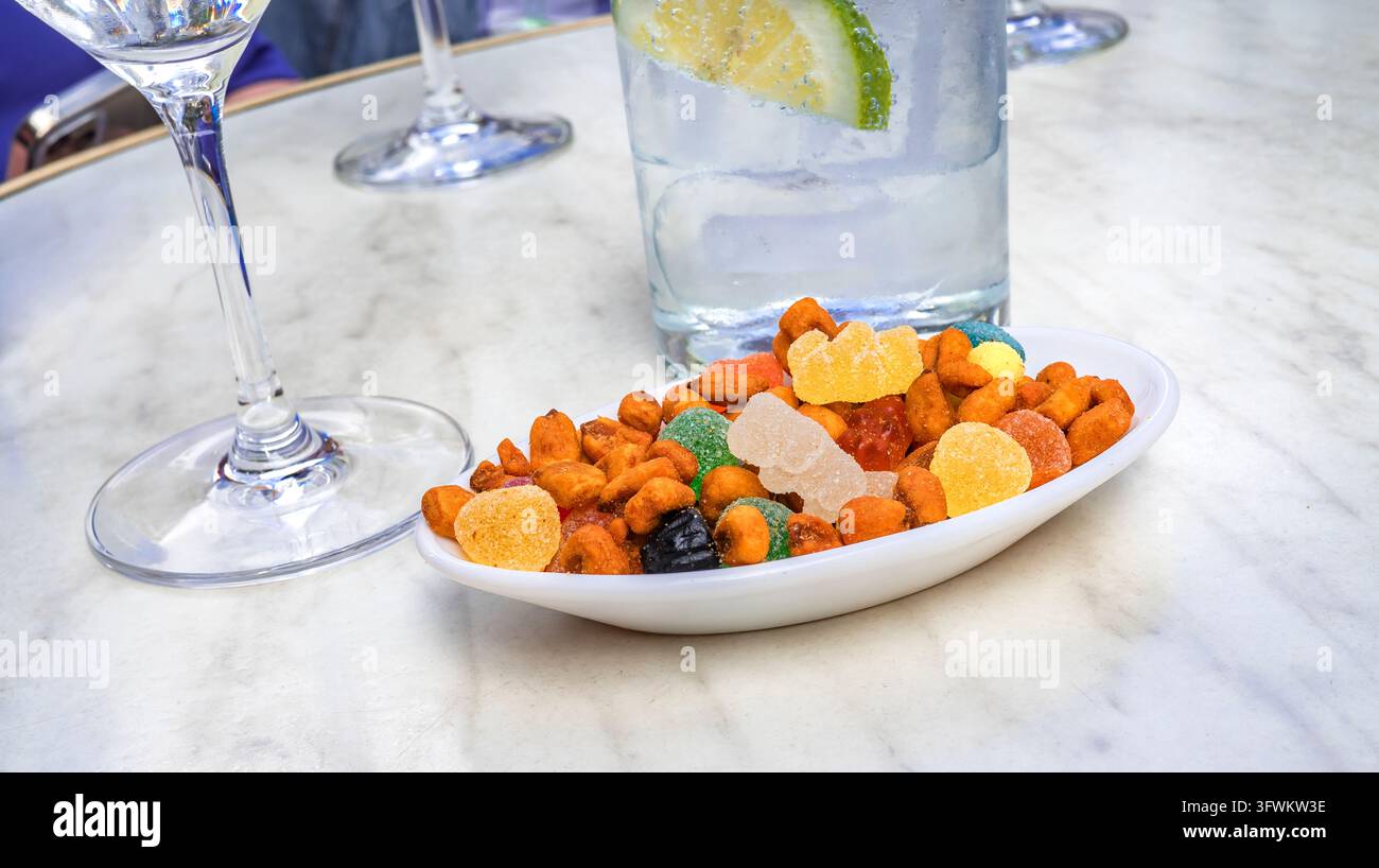 Gin Tonic avec hors-d'œuvre sucré salé Banque D'Images