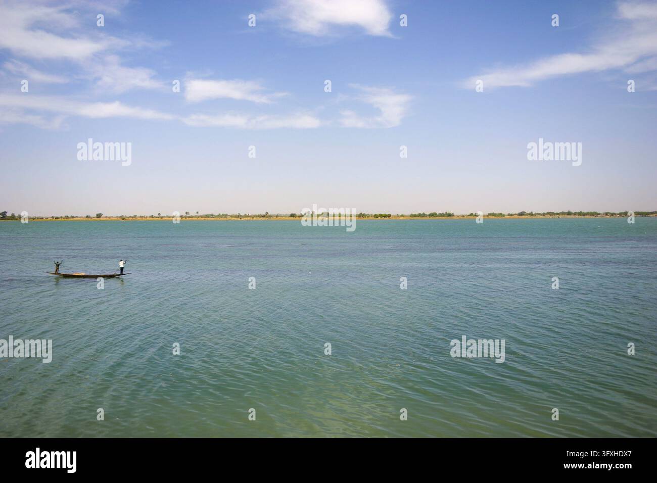 Deux personnes dans une pirogue sur le large fleuve calme du Niger, région de Segou, Segou, Mali Banque D'Images