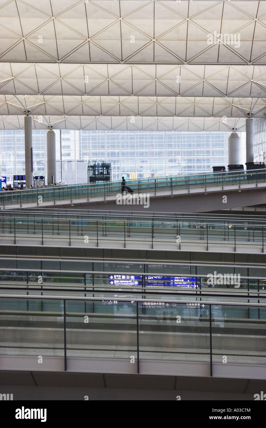 Passager solitaire marchant dans la bretelle de l'Aéroport International de Hong Kong Banque D'Images