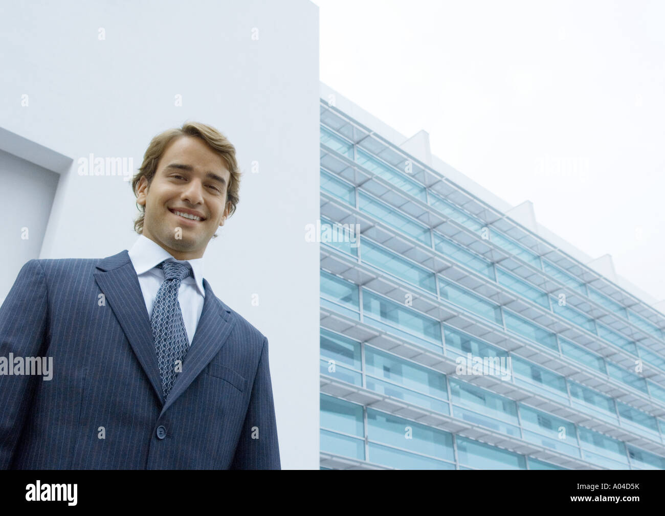 Businessman, portrait, standing in front of office building Banque D'Images