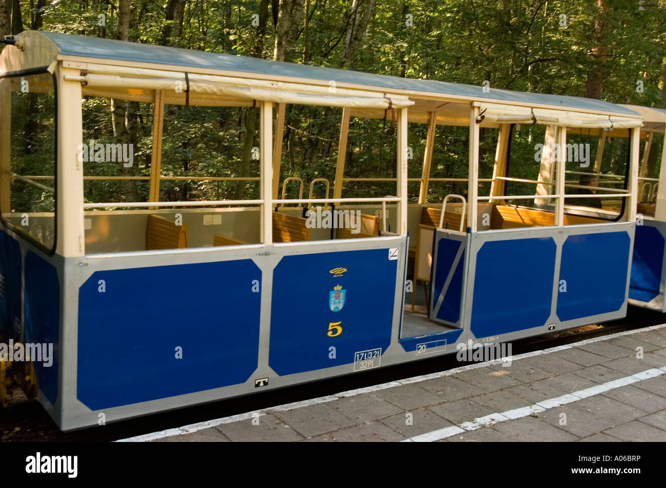 Malta Toy train à Poznan, Pologne, reliant le centre-ville et le jardin zoologique. Wagon de chemin de fer à voie étroite bleu et blanc ouvert dans une forêt. Banque D'Images