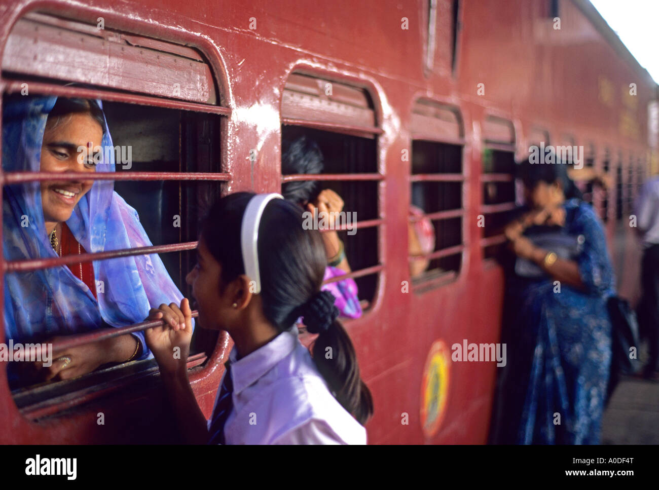 Femme indienne et sa fille parler à travers la vitre d'un train à la gare de Mumbai Inde Banque D'Images