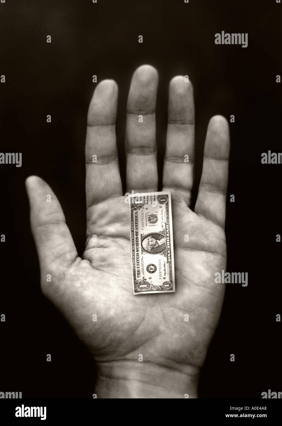 Un petit U S dollars dans une main Concepts Banque D'Images