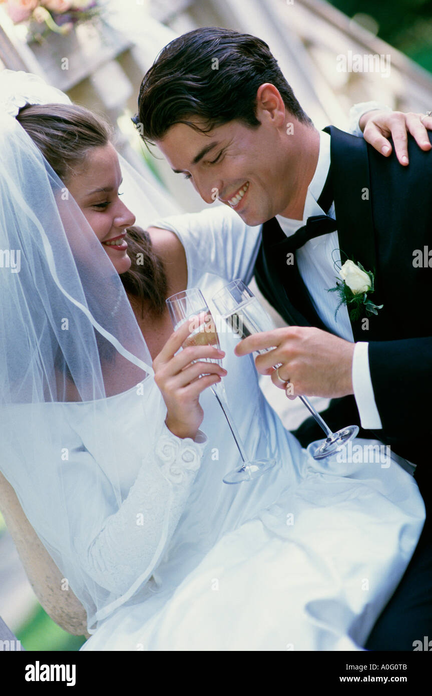 Newlywed couple toasting with glasses of champagne Banque D'Images