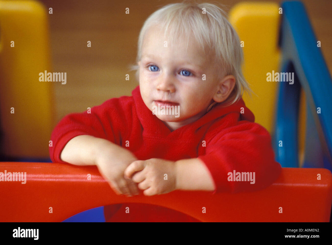 1 Un jeune garçon blond mâle red jacket enfant 2 ans curieux porche d'été attention seeker caucasian Banque D'Images