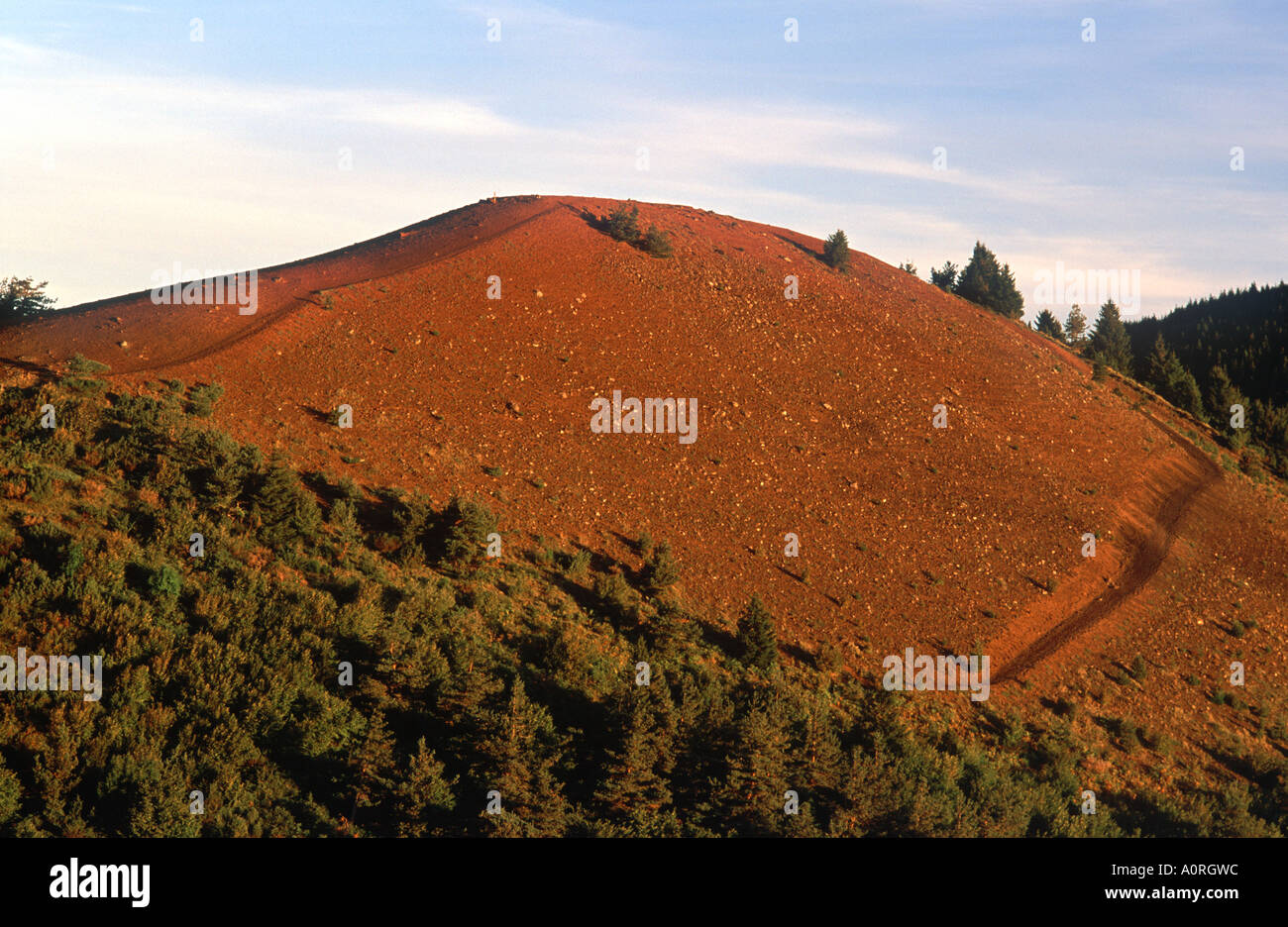 Soleil du matin sur la terre rouge du volcan Puy de Lassolas avec sentier pédestre, Parc Naturel Régional des Volcans d'Auvergne, France Banque D'Images