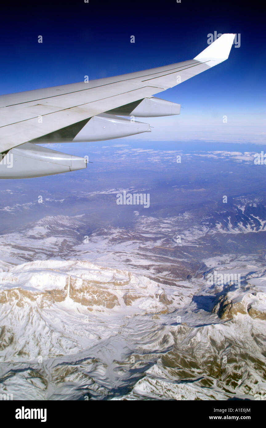 Aile d'avion Airbus plane au-dessus de montagnes du Caucase et ciel bleu azur haute altitude Banque D'Images