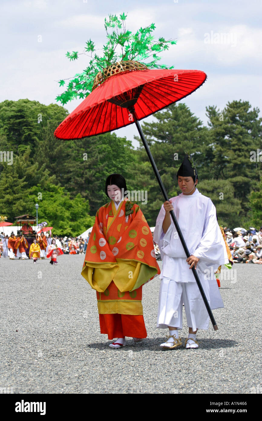 Les participants à l'Aoi Matsuri festival à pied avec un parapluie rouge  portant costume 6e siècle à Kyoto au Japon Photo Stock - Alamy