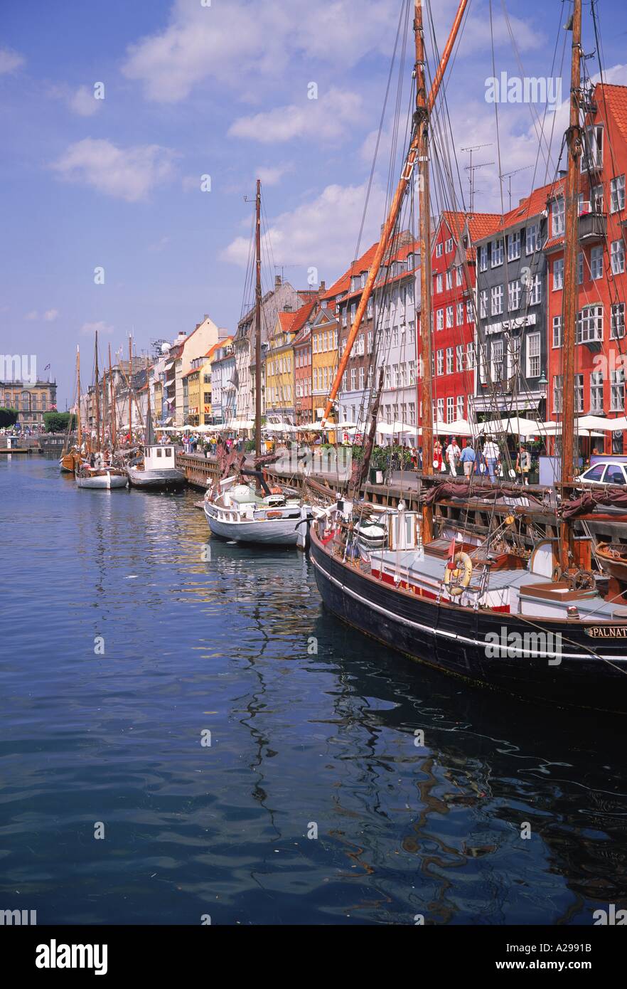 Bateaux amarrés et cafés en plein air sur le front de la canal de Nyhavn le vieux port de Copenhague Danemark La photo Store Banque D'Images