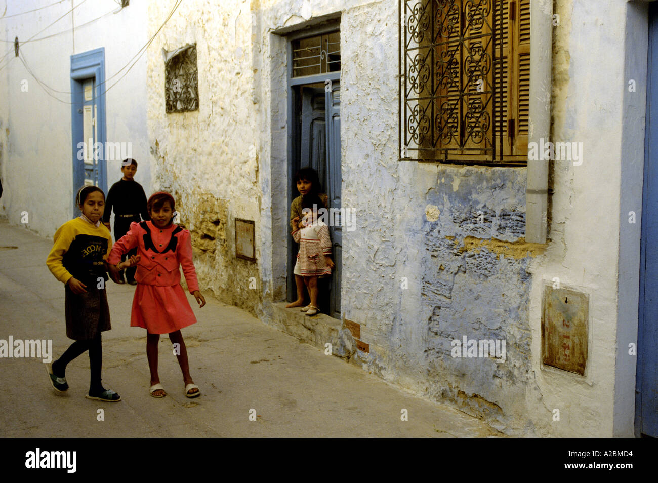 Les filles jouent dans une rue latérale du Maroc Banque D'Images