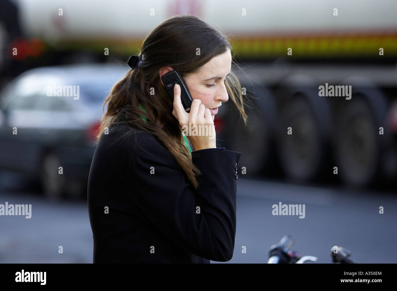 Long dark haired girl irlandaise avec pince à cheveux vêtu de noir veste de  costume sur un téléphone mobile Nokia en face du trafic à Dublin Photo  Stock - Alamy