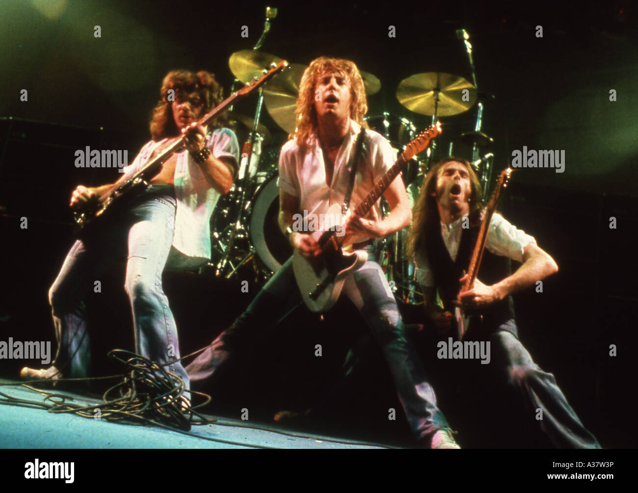 Statu quo à propos de 1980 de gauche Alan Lancaster, Rick Parfitt et Francis Rossi Banque D'Images