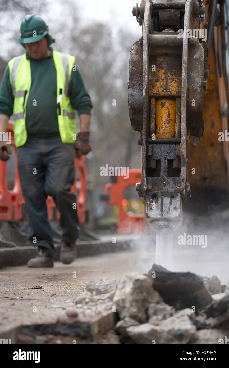 Workman creuser jusqu'à la route Banque D'Images