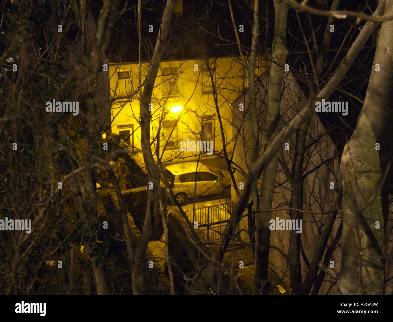 Voiture garée à l'extérieur à la maison la nuit Banque D'Images