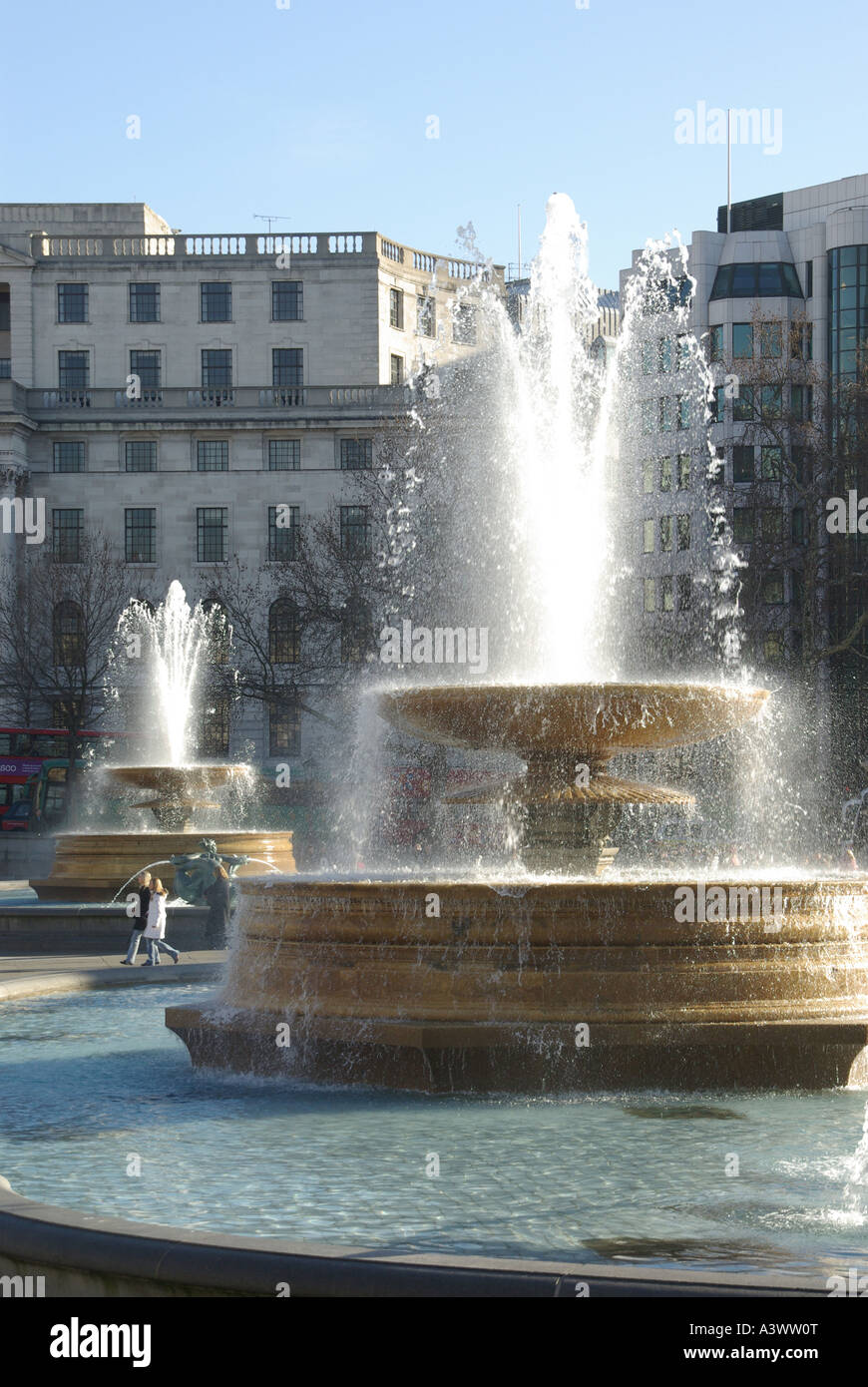 Tôt le matin à Trafalgar Square avec le tourisme fontaine eau disposent d'affichage avant de foules arrivent et tournant à pleine hauteur près de London England UK Banque D'Images