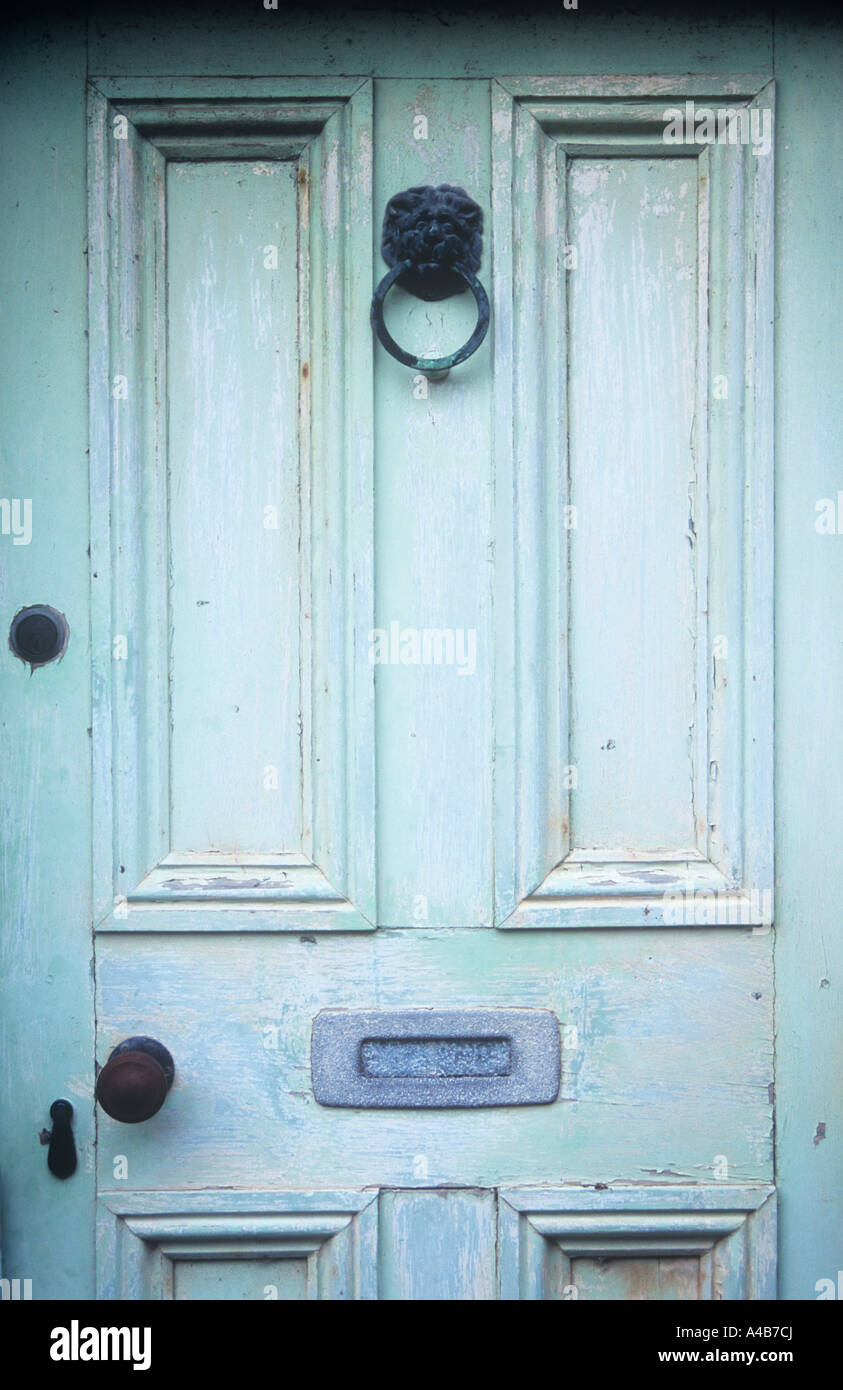 Détail des panneaux de porte d'un vert pâle avec les lions head knocker petite poignée de porte et serrures letterbox terni Banque D'Images