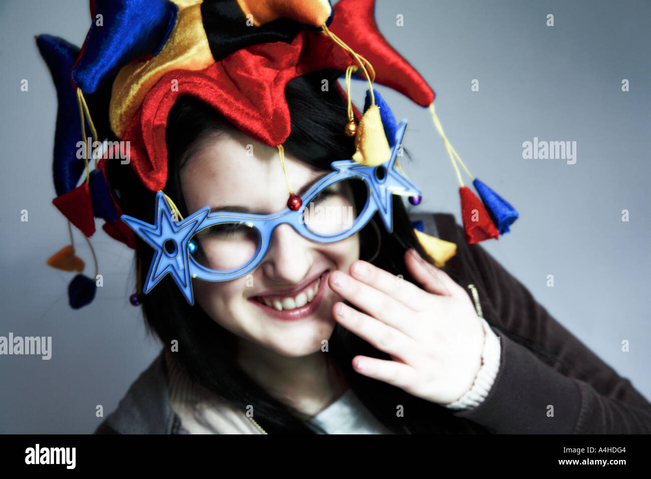 Jeune femme avec chapeau jesters et lunettes nouveauté laughing Banque D'Images