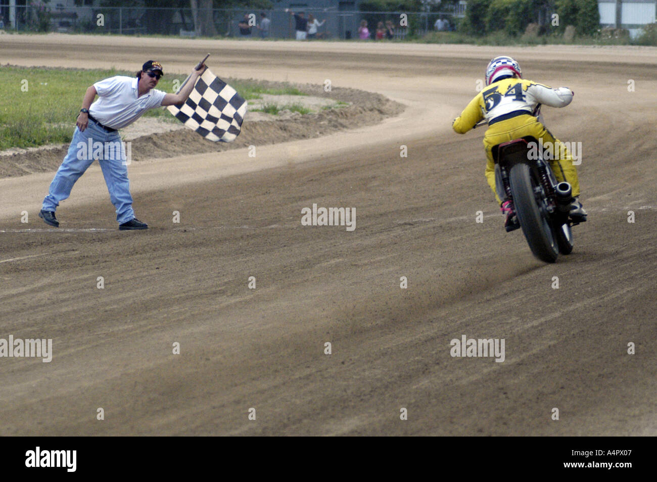 RF 54 racer habillé en jaune prend le drapeau à damier lors de dirt track course moto Croswell Michigan USA Banque D'Images