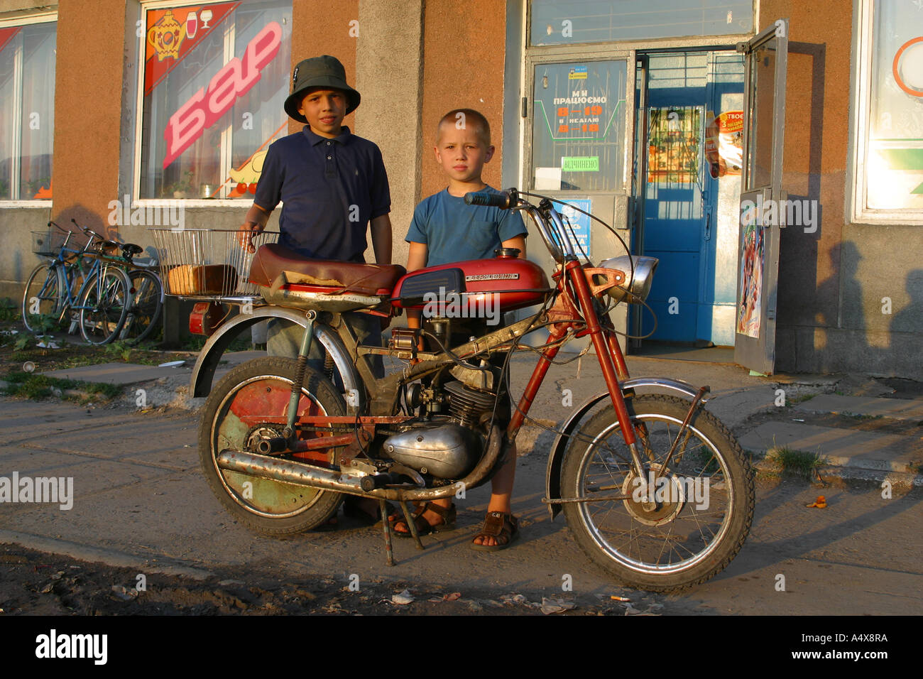 L'Ukraine, Zhashkiv, 2002. Les adolescents qui posent avec un vieux vélo Banque D'Images