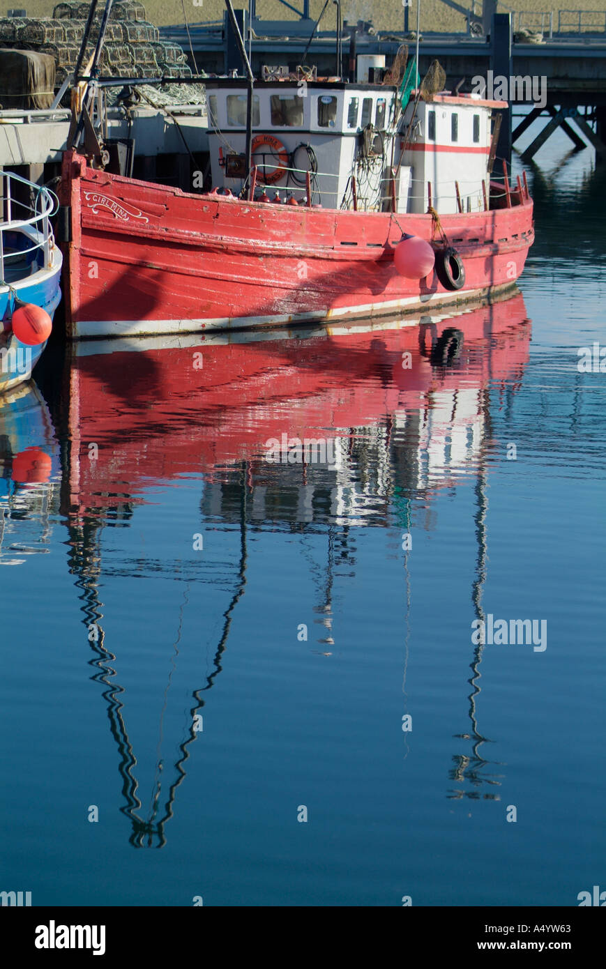 Le port de STROMNESS ORKNEY Stromness dh coque rouge chalutier converti en bateau de plongée plongée quayside refléter Banque D'Images