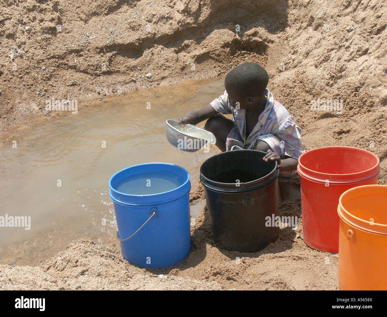 Iy7582 enfant Painet Tanzanie la collecte de l'eau sale et lit d'une rivière asséchée au pays en développement, de pays moins shinyanga Banque D'Images