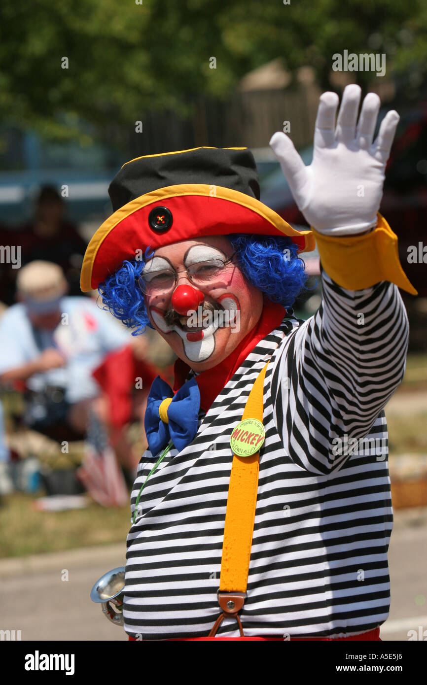 Un clown agitant à la foule lors d'un défilé du 4 juillet. Banque D'Images