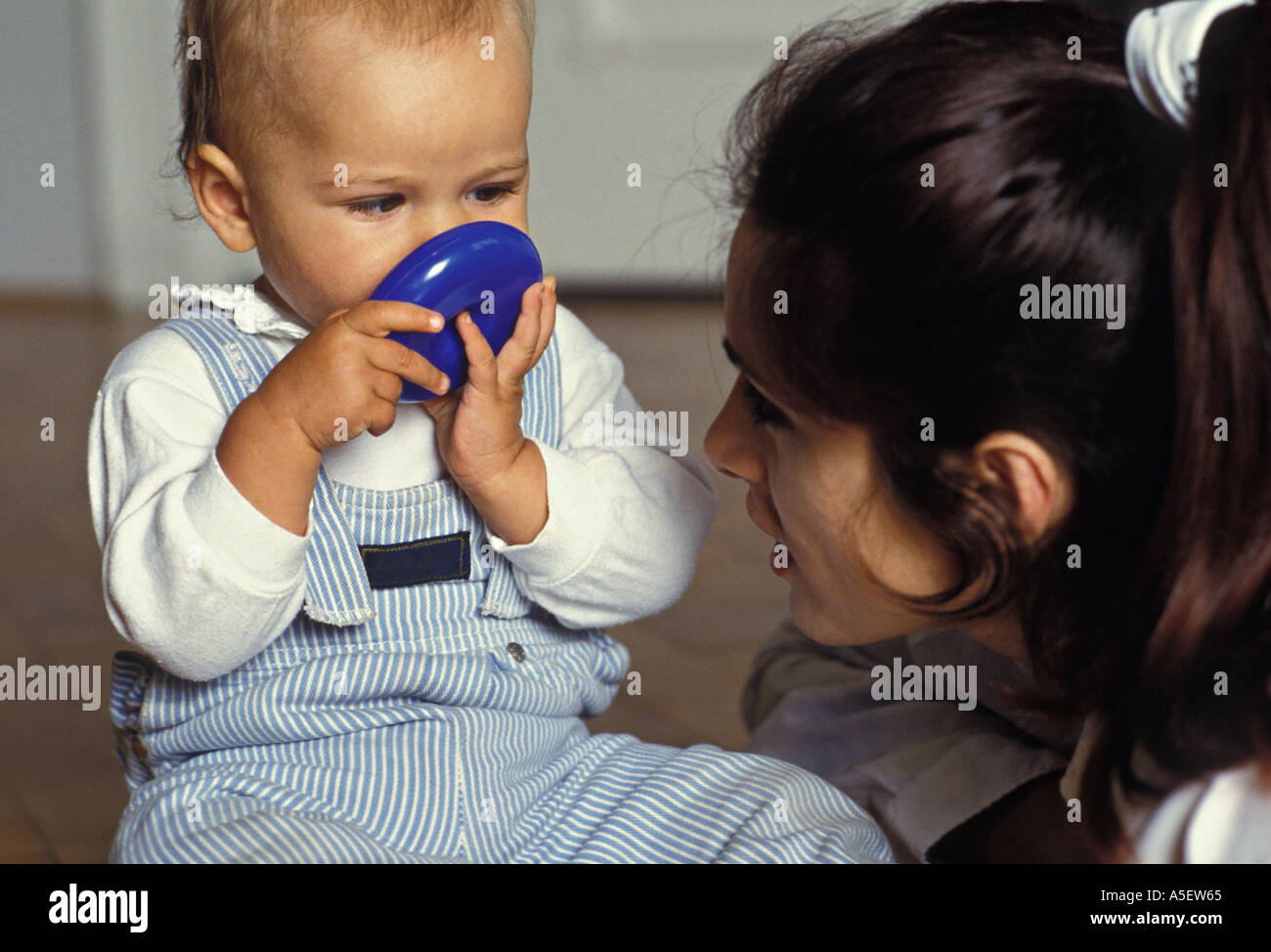 Bébé jouant alors que mère watches Banque D'Images