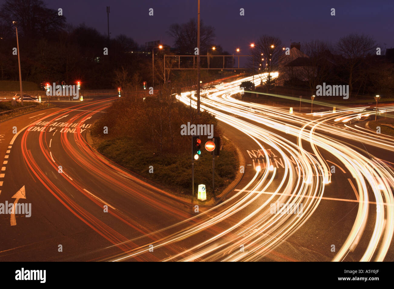 Des sentiers de lumière causé par le trafic d'une route très fréquentée à l'intersection avec feux de circulation England UK Banque D'Images Des sentiers de lumière causé par le trafic d'une route très fréquentée à l'intersection avec feux de circulation England UK Banque D'Images