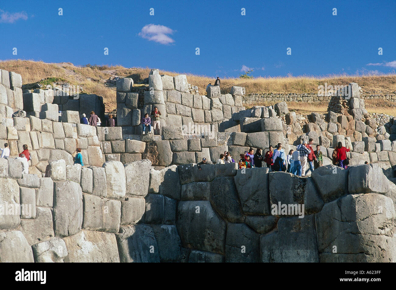 Amérique du Sud PÉROU Cusco Sacsayhuman personnes marchant le long de la partie supérieure de l'Inca de murs en pierre Banque D'Images