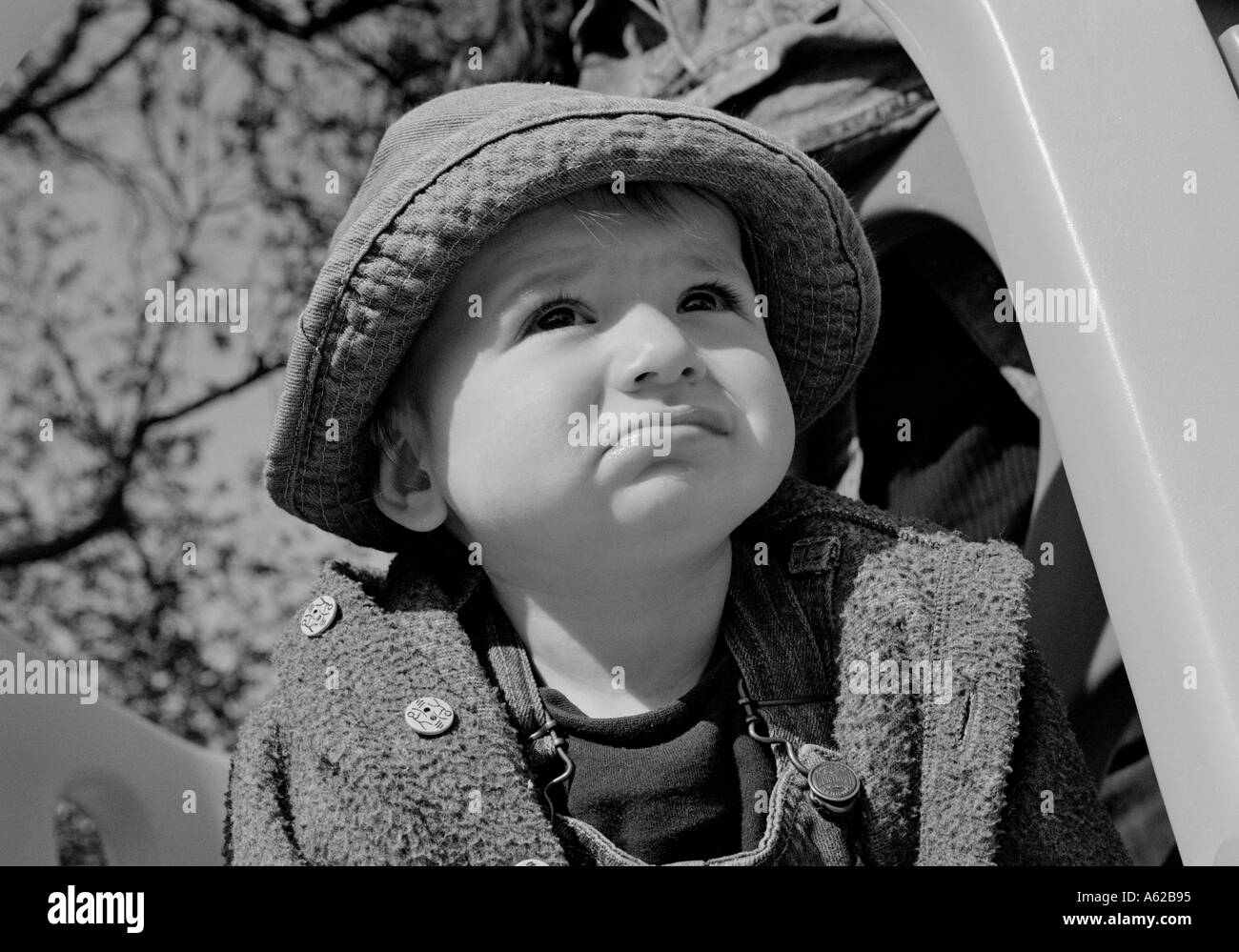 De récolte serré bébé garçon regardant vers le haut dans la lumière du soleil Banque D'Images