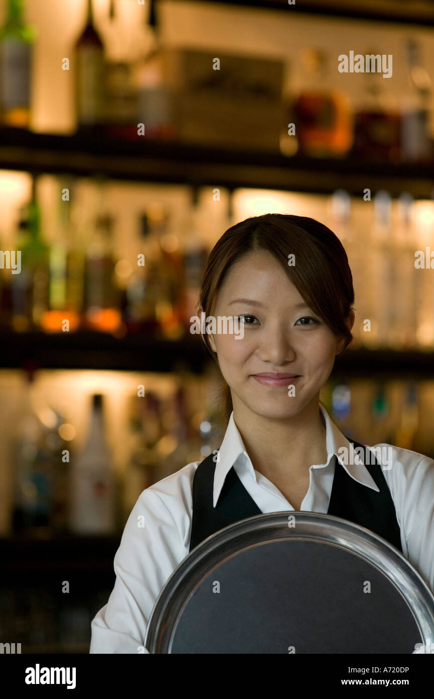 Waitress holding tray Banque D'Images
