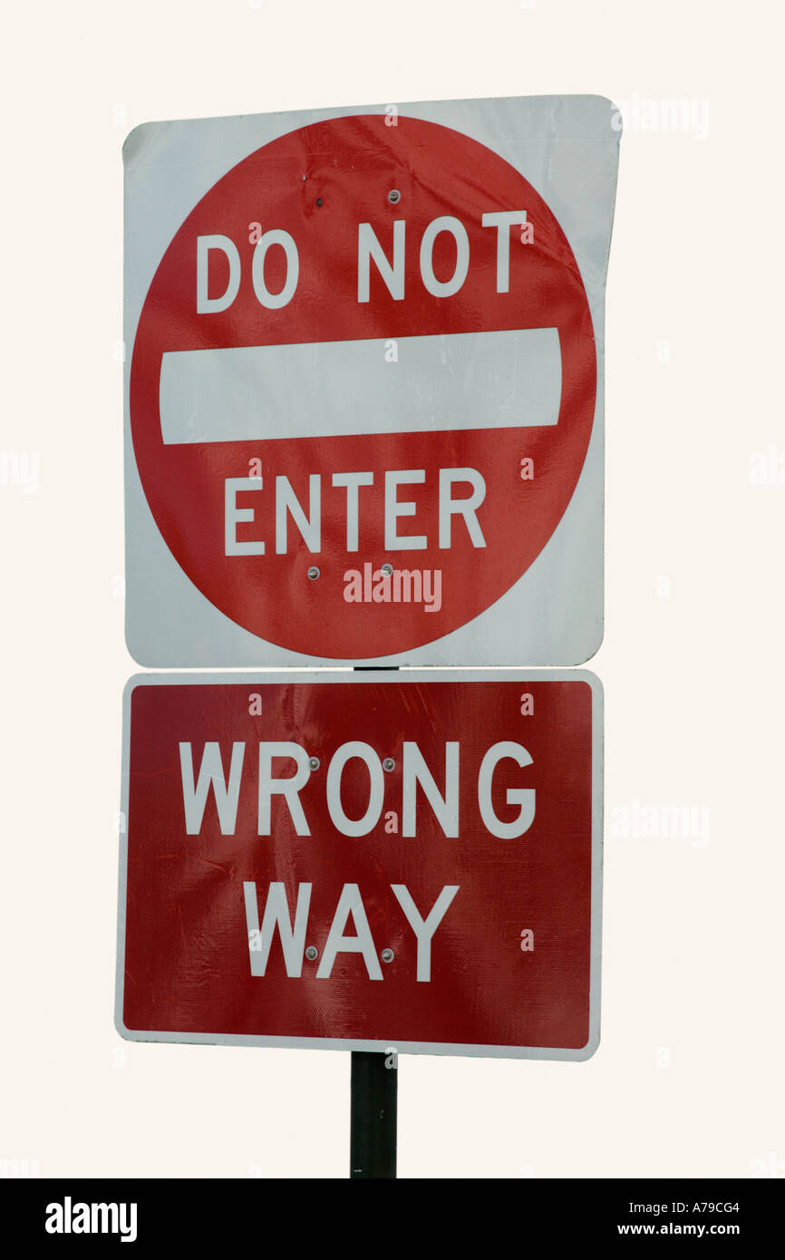 Interdiction n'entrez pas de mauvaise façon road cut out panneau de circulation accompagné du code de la route pour les conducteurs de voitures rouges perception de danger metal Banque D'Images